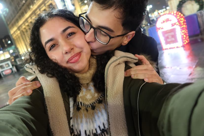 Us kissing next to Christmas tree