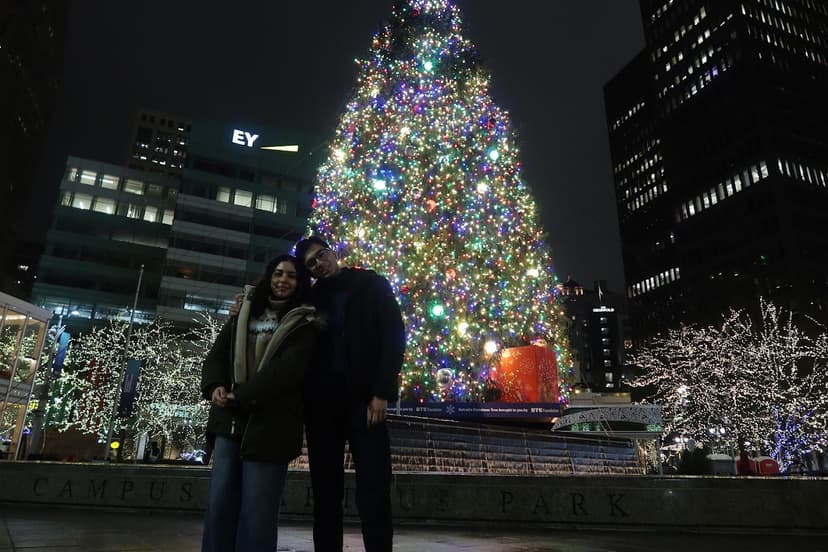 Us next to Christmas tree